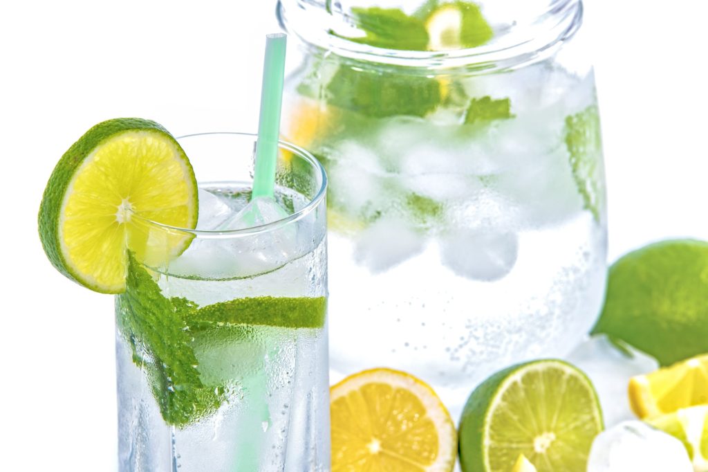 A glass and pitcher of stevia lemon and limeade